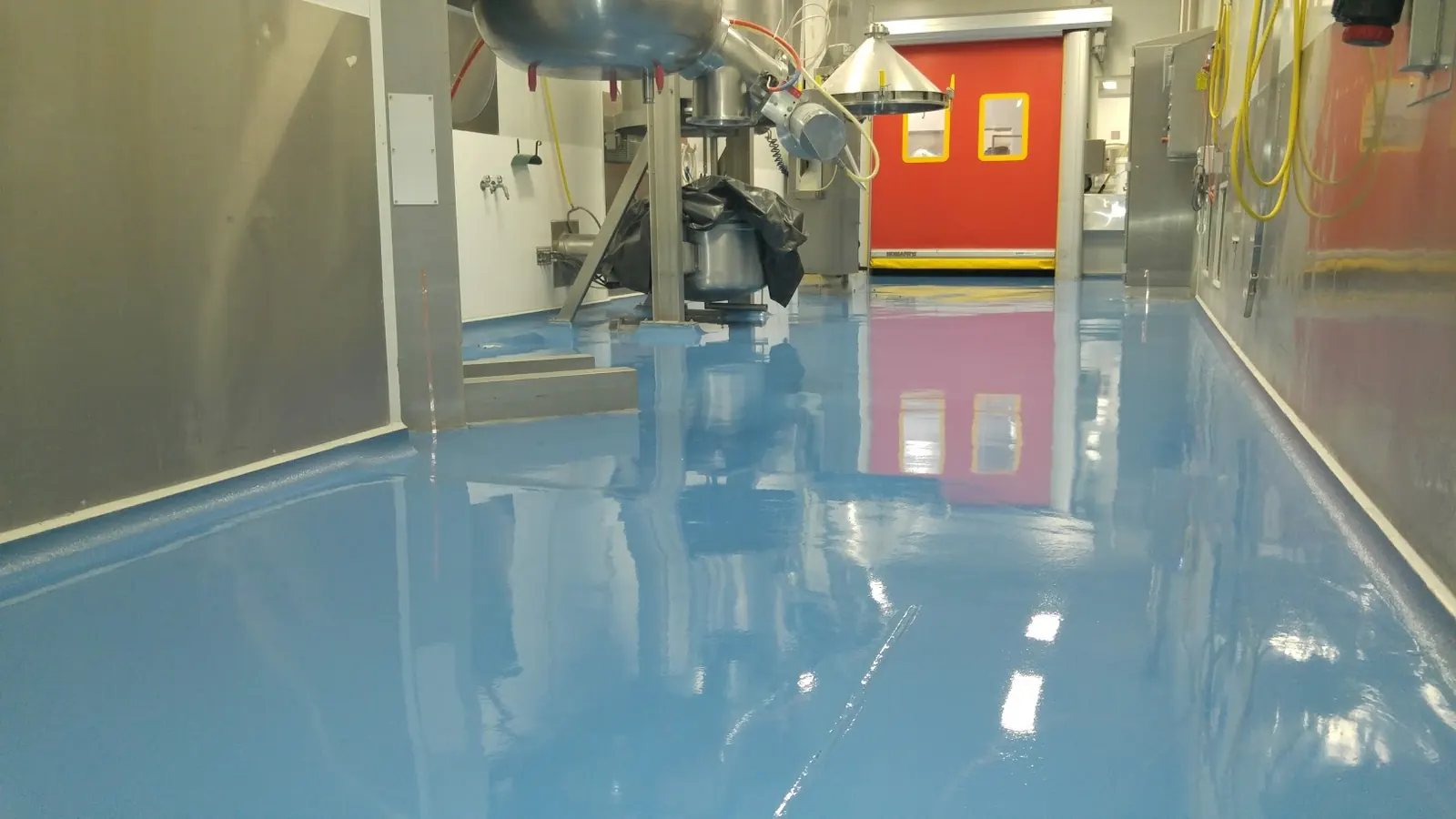 Blue industrial epoxy floor system in a workshop