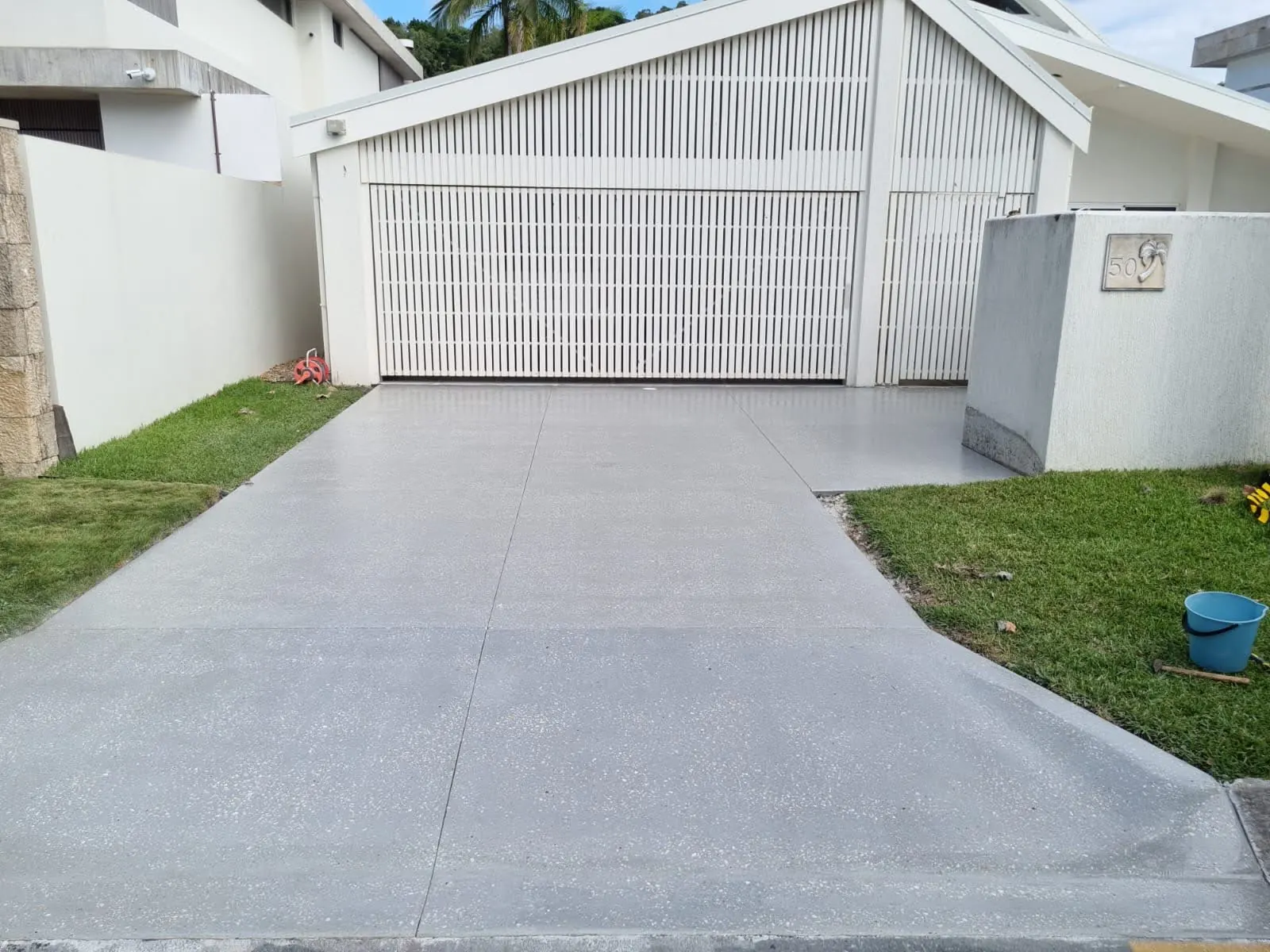 Residential driveway finished with a decorative concrete coating